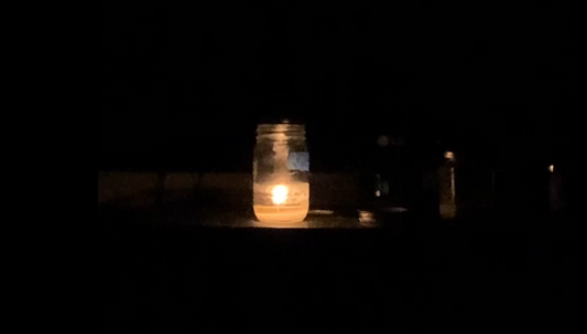 Serenity candle burning in dark room